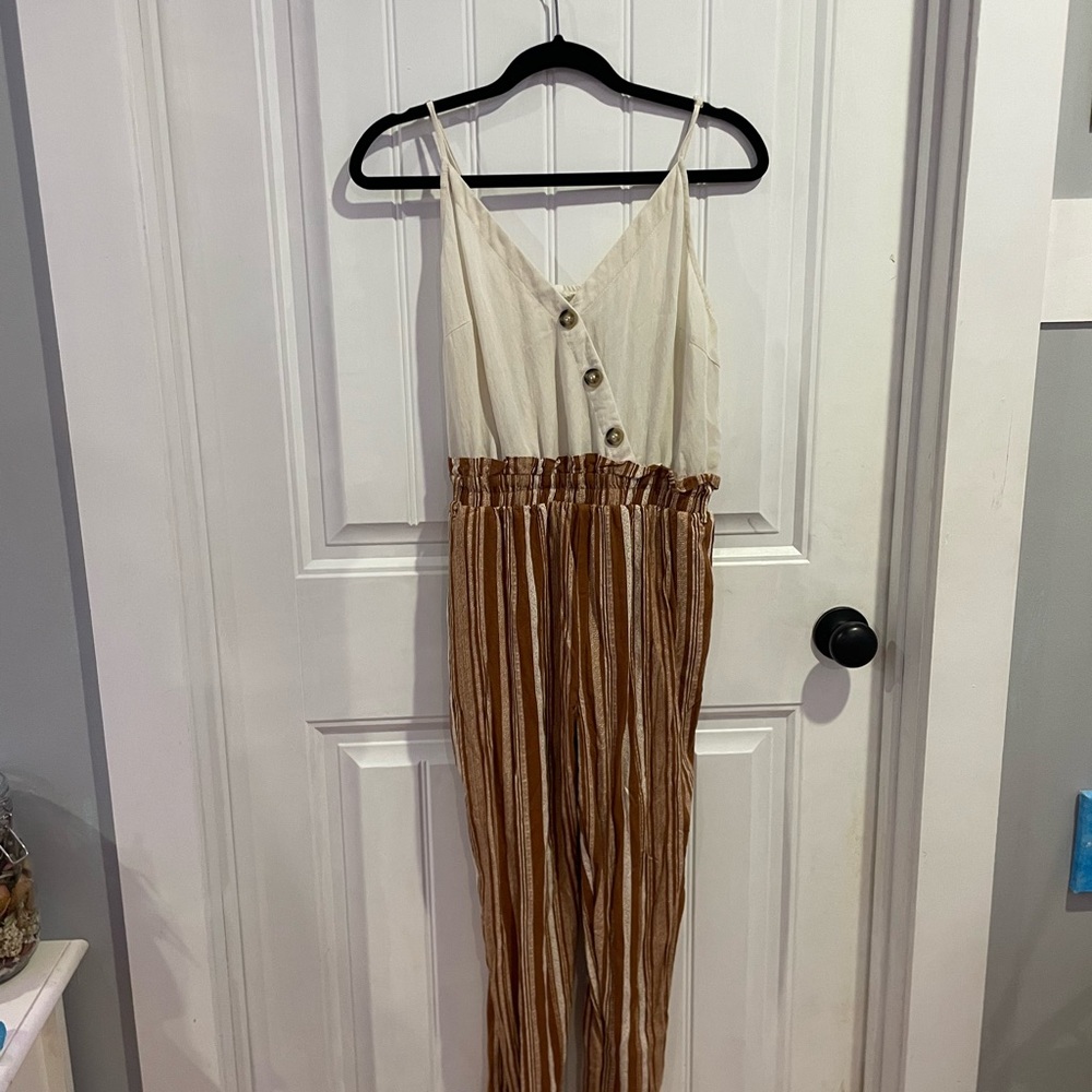 Rusty orange and cream colored romper with pockets. Size large